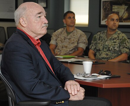 Assistant Secretary of the Navy, the Honorable Dennis V. McGinn, Energy, Installations and Environment, listens to an I&E command brief given by Fred Broome, director, Installation and Environment Division, Marine Corps Logistics Base Albany, Georgia, during his visit here, May 19.