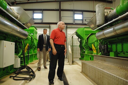 Assistant Secretary of the Navy, the Honorable Dennis V. McGinn (right), Energy, Installations and Environment, tours the landfill gas-to-energy project with Fred Broome, director, Installation and Environment Division, Marine Corps Logistics Base Albany, Georgia, during his visit here, May 19. The landfill gas-to-energy project is the first-of-its-kind within the Department of the Navy. It uses a 1.9 megawatt combined heat and power generator to recover methane gas from a neighboring landfill and converts it into energy and steam to help power Marine Depot Maintenance Command. A second generator is currently being installed, which will bring the plant’s total capacity up to 4.0 megawatts. 