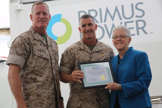 Brigadier Gen. Edward Banta, the Marine Corps Installations West commanding general, and Col. John Farnam, Marine Corps Air Station Miramar commanding officer, accept the 2015 Environmental Protection Agency Federal Green Challenge Award for Energy from Gina McCarthy, the EPA administrator May 20 at the public works building on MCAS Miramar, California. In 2014, MCAS Miramar had the greatest percentage reduction in energy use nationally and cut its fuel oil consumption by 98%.