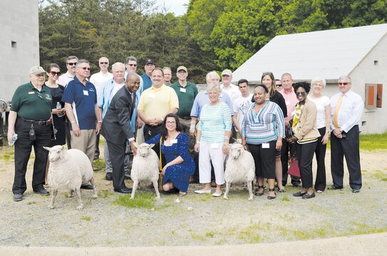 Members of the Fredericksburg Military Affairs Council toured Marine Corps Base Quantico on May 12 and observed training in the MOUT facility, pausing to pose for a photo with some of the props that make the setting more realistic.