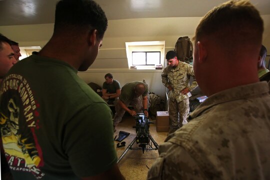 Marines with Weapons Company, 3rd Battalion, 3rd Marine Regiment, observe as Marines race to disassemble the MK19 machine gun during training exercise Lava Viper, one of the staples of their pre-deployment training, aboard Pohakuloa Training Area, Hawaii, Oct. 22, 2015. Lava Viper provides the Hawaii-based Marines with an opportunity to conduct various movements, live-fire and tactical training before departing for Integrated Training Exercise aboard Marine Air-Ground Combat Center Twentynine Palms, Calif., where the battalion will train and be evaluated as a whole. "Trinity" strives to fight and win on both the tactical and ethical battlefield, always cultivating the values of honor, courage, and commitment, ultimately producing morally guided citizens whose obligations and responsibilities supersede rights and privileges. (U.S. Marine Corps photo by Lance Cpl. Harley Thomas)