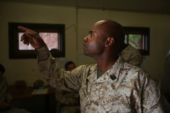 Gunnery Sgt. Leland Braun, the Lima Company gunnery sergeant with 3rd Battalion, 3rd Marine Regiment, and Seminole, Texas, native, asks questions about the battalion’s upcoming schedule during training exercise Lava Viper, one of the staples of their pre-deployment training, aboard Pohakuloa Training Area, Hawaii, Oct. 22, 2015. Lava Viper provides the Hawaii-based Marines with an opportunity to conduct various movements, live-fire and tactical training before departing for Integrated Training Exercise aboard Marine Air-Ground Combat Center Twentynine Palms, Calif., where the battalion will train and be evaluated as a whole. "Trinity" strives to fight and win on both the tactical and ethical battlefield, always cultivating the values of honor, courage, and commitment, ultimately producing morally guided citizens whose obligations and responsibilities supersede rights and privileges. (U.S. Marine Corps photo by Lance Cpl. Harley Thomas)
