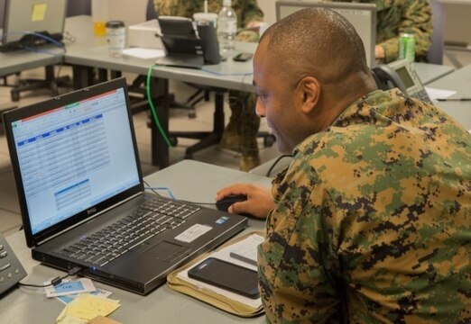 Maj. Thesolina Hubert, a maintenance operations officer with Headquarters and Service Company, 2nd Marine Logistics Group, manages operations status' during the 2nd MLG Staff Exercise at Camp Lejeune, N.C., Nov. 4, 2015. The two-week exercise was focused on the refinement of planning and developing more efficient standard operating procedures in preparation for the II Marine Expeditionary Force Exercise in the spring of 2016.