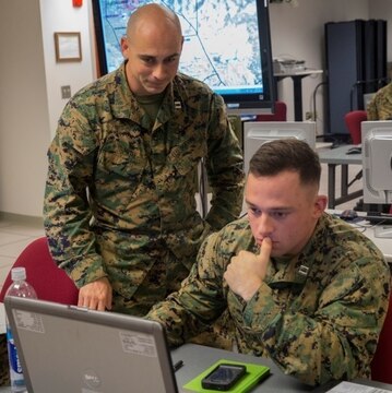 Capt. Stephen Mulcahy, right, an anti-terrorism force protection officer with 2nd Marine Logistics Group, works on a scheme of maneuver during the 2nd Marine Logistics Group Staff Exercise at Camp Lejeune, N.C., Nov. 4, 2015. Officers and staff noncommissioned officers from subordinate commands within 2nd MLG integrated during the exercise to simulate uninterrupted support to Marine forces at the Marine Expeditionary Force level.