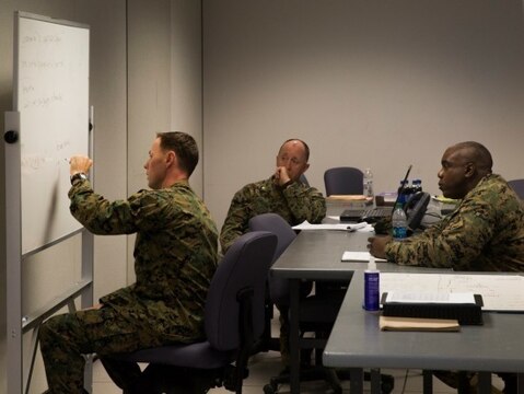 Maj. Ryan Shea, a future operations officer with 2nd Marine Logistics Group, writes strategic planning methods on a whiteboard during the 2nd MLG Staff Exercise at Camp Lejeune, N.C., Nov. 4, 2015. The exercise, a command control scenario, was conducted with efforts to refine the group's planning and execution process that would act as a standard for subordinate commands.