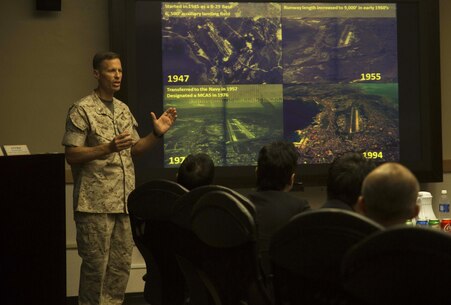 Masaoki Fukui, left, exchanges business cards with Lt. Col. James J. Hurd during a visit and educational tour October 14 on Marine Corps Air Station Futenma. During the visit, chairmen of the Japan-Russia Friendship Association were informed about the history and tenant units of MCAS Futenma and their capabilities. After a question and answer session, the guests boarded a bus for a windshield tour of the installation. Fukui is a chairman with the Japan-Russia Friendship Association. Hurd is the executive officer of MCAS Futenma, Marine Corps Installations Pacific and a Kingston, New Hampshire, native.