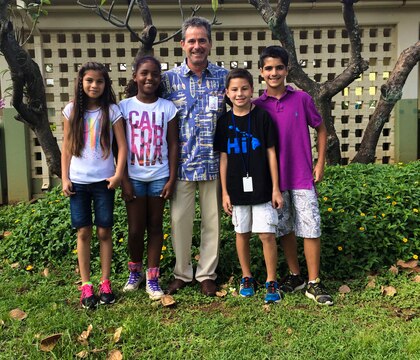 MARINE CORPS BASE HAWAII - Chuck Fradley, the principal of Mokapu Elementary School, stands with four students who wished Robin Lopes, a sixth grade teacher of Mokapu Elementary School, a speedy recovery from her accident at Mokapu Elementary School aboard Marine Corps Base Hawaii Nov. 9, 2015. Lopes crashed her bike Oct. 15, 2015, when she was coming into work one morning. “I can’t wait to get back to work,” Lopes said. (U.S. Marine Corps photo by Cpl. Khalil Ross)