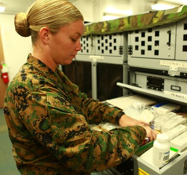 MARINE CORPS BASE HAWAII - Petty Officer 1st Class Janelle Mattern, the leading petty officer of Medical Logistics, Support Company, Combat Logistics Battalion 3, sorts through medical supplies in the medical room at CLB-3 aboard Marine Corps Base Hawaii Nov. 3, 2015. Mattern along with four Marines from 1st Battalion, 3rd Marine Regiment rushed to the aid of Robin Lopes, a sixth grade Mokapu Elementary School teacher, who had suffered lacerations to her knee from a bicycle accident which took place Oct. 15, 2015. “I heard someone yell ‘corpsman,’” said Mattern, a Pittsburg, Pa. native. “I looked toward the school across the street and saw her lying down on the ground. I sprinted over and saw a significant amount of blood coming from knee lacerations.”(U.S. Marine Corps photo by Lance Cpl. Zachary Orr)