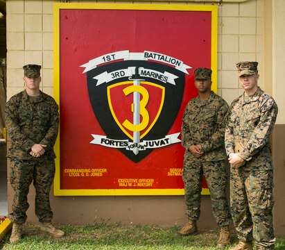 MARINE CORPS BASE HAWAII - Sgt. Kyle Dougherty, a field radio operator with 1st Battalion, 3rd Marine Regiment, Sgt. Jordan Rodriguez, a cyber network operator with 1st Bn., 3rd Marines and Sgt. Craig Coursin, a data network specialist with 1st Bn., 3rd Marines, stand beside their unit sign aboard Marine Corps Base Hawaii, Nov. 5, 2015. These Marines sailors rushed across the street to the scene where Robin Lopes, a sixth grade teacher at Mokapu Elementary School, was lying on the ground after she had a bicycle accident in the school parking lot. “I’ll always tell people from now on if they were to get hurt, pray there is a Marine Corps base around because literally a corpsman came and I was surrounded by Marines,” Lopes said.  (U.S. Marine Corps photo by Lance Cpl. Zachary Orr)