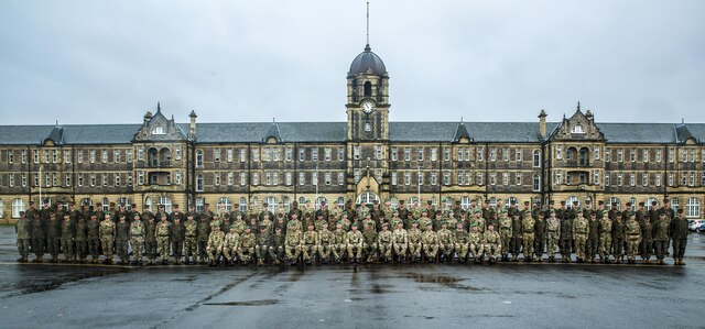 U.S. Marines with 2nd Intelligence Battalion and British soldiers pose for a photo as they conclude Exercise Phoenix Odyssey II in front of the Redford Barracks in Edinburgh, U.K., Nov. 7, 2015. This was the second consecutive year that both forces came together to conduct the exercise, which enhances joint intelligence operations and strengthens the relationship between the two forces. (U.S. Marine Corps photo by Lance Cpl. Erick Galera/Released)