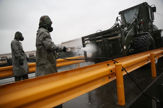 Reconnaissance, surveillance and decontamination Marines decontaminate a John Deere TRAM 624KR tractor during a simulated chemical attack at the Marine Wing Support Squadron 171 motor transportation wash rack at Marine Corps Air Station Iwakuni, Japan, Nov. 18, 2015. As part of an operational decontamination exercise, this mock attack refreshes RSD personnel’s skills in a chemical, biological, radiological and nuclear environment while preparing them for potential real world situations.