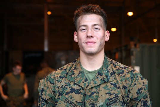 Pfc. Raymond Ramirez, an embarkation Marine with Marine Wing Support Squadron 171, poses after successfully completing an operational decontamination exercise at the MWSS-171 motor transportation wash rack at Marine Corps Air Station Iwakuni, Japan, Nov. 18, 2015. Ramirez was one of the multiple Marines to finish the five-phase exercise aimed to increase combat proactivity and readiness in a chemical, biological, radiological and nuclear environment.