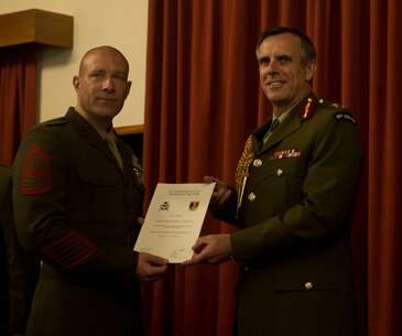 U.S. Marine Corps Sgt. Maj. Christian L. Charkowski, left, receives his graduation certificate from New Zealand Defence Force Lt. Gen. Tim Keating, at the Defence Force Command and Staff College, Wellington, New Zealand, Nov. 19, 2015. Charkowski is the first U.S. Marine and second U.S. service member to graduate from the college. He attended the Joint Warrant Officers’ Advanced Course there, where the objectives were to prepare senior level leaders for senior strategic advisory positions, increase the students’ knowledge of regional security for the South West Pacific and provide insight into the workings of the government. Charkowski, from Madison, Wisconsin, is the battalion sergeant major for 3rd Combat Assault Battalion, 3rd Marine Division, III Marine Expeditionary Force. Keating is the Chief of Defence for the New Zealand Defence Force. (Marine Corps. photo by Cpl. Tyler S. Giguere/Released)