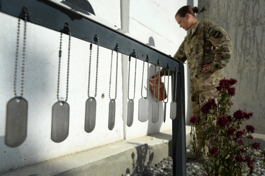 U.S. Air Force Tech. Sgt. Valarie, Train, Advise, Assist Command – Air (TAAC-Air), waters the flowers around the NATO Air Training Command – Afghanistan (NATC-A) Nine Memorial Forward Operating Base Oqab, Afghanistan, Sept. 22, 2015. The 438th Air Expeditionary Advisor Group with funds and donations by the Enlisted Coalition Council built the NATC-A Nine Memorial in April 2013. (U.S. Air Force photo by Staff Sgt. Sandra Welch/released)