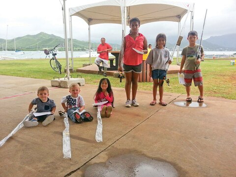 MARINE CORPS BASE HAWAII — Participants in the children’s category of the Night Shoreline Fishing Tournament pose for a photo in between catch-and-release fishing at the base marina, Sept. 26, 2015. The Night Shoreline Fishing Tournament featured prizes in two categories: Adults and children, who were 12 years old and younger. Each child received a free fishing rod for participating. Appearing in order from left to right: Carter Gomez; Conner Gomez; Aria Guieb; Alex Lacalamito; Kaitlyn Morales and Ethan Rau. The tournament was the first of its kind hosted by marina staff and part of Marine Corps Community Services’ ongoing mission to assist service members and civilians. The marina staff provides facilities, programs and services in direct support of the MCB Hawaii community for recreation using the installation’s available resources. (Photo courtesy of Marine Corps Base Hawaii’s Outdoor Recreation Center and Marina)