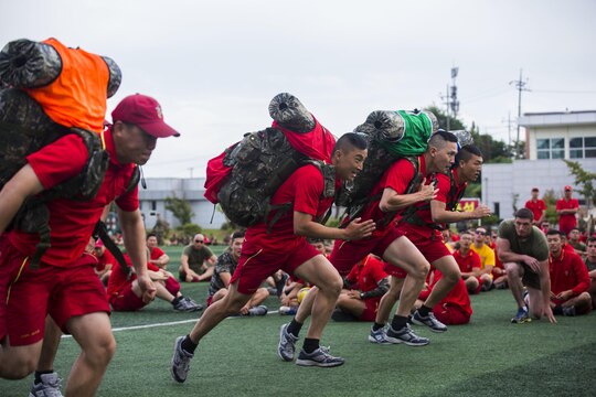 U.S. and Republic of Korea Marines cheer on participants in a ruck run relay race during Korean Marine Exchange Program 15-12 at Chung Ryong, Republic of Korea, Sept. 12, 2015. KMEP 15-12 is a continuous bilateral training exercise that enhances the ROK and U.S. alliance, promotes stability on the Korean Peninsula and strengthens ROK and U.S. military capabilities and interoperability. The ROK Marines are with 11th Battalion, 1st Regiment, 2nd Marine Division. The U.S. Marines are with 2nd Battalion, 3rd Marine Division, currently attached to 4th Marine Regiment, III Marine Expeditionary Force through the Unit Deployment Program.