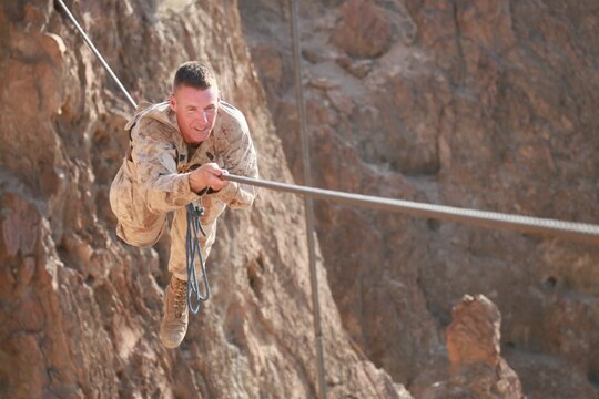 ARTA BEACH, Djibouti (Sept. 28, 2015) U.S. Marine 1st Sgt. Garett Kirkby balances on a cable obstacle during a desert survival course alongside the French 5th Overseas Combined Arms Regiment (RIAOM). Kirkby is the company 1st Sgt. of Delta Company, 1st Light Armored Reconnaissance Detachment, Battalion Landing Team 3rd Battalion, 1st Marine Regiment, 15th Marine Expeditionary Unit. Elements of the 15th MEU are training with the 5th RIAOM in Djibouti in order to improve interoperability between the MEU and the French military. (U.S. Marine Corps photo by Sgt. Steve H. Lopez/Released)
