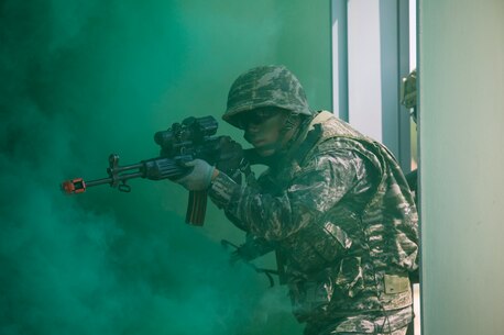 Republic of Korea Marine Cpl. Geon Shin breaches a building alongside U.S. Marines under smoke concealment during Korean Marine Exchange Program 15-12 at Gunha-Rhi, Gimpo, Republic of Korea, Sept. 17, 2015. KMEP 15-12 is a bilateral training exercise that enhances the ROK and U.S. alliance, promotes stability on the Korean Peninsula and strengthens ROK and U.S. military capabilities and interoperability. Shin, from Mokpo, ROK, is a rifleman with 1st Company, 11th Battalion, 1st Regiment, 2nd Marine Division. The U.S. Marines are with Fox Company, 2nd Battalion, 3rd Marine Regiment, currently assigned to 4th Marine Regiment, 3rd Marine Division, III Marine Expeditionary Force under the unit deployment program.