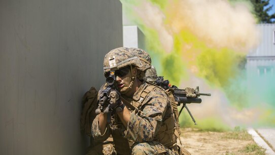 U.S. and ROK Marines breach a building under smoke concealment during Korean Marine Exchange Program 15-12 at Gunha-Rhi, Gimpo, Republic of Korea, Sept. 17, 2015. KMEP 15-12 is a bilateral training exercise that enhances the ROK and U.S. alliance, promotes stability on the Korean Peninsula and strengthens ROK and U.S. military capabilities and interoperability. The ROK Marines are with 1st Company, 11th Battalion, 1st Regiment, 2nd Marine Division. The U.S. Marines are with Fox Company, 2nd Battalion, 3rd Marine Regiment, currently assigned to 4th Marine Regiment, 3rd Marine Division, III Marine Expeditionary Force under the unit deployment program. (U.S. Marine Corps photo by Cpl. Tyler S. Giguere/ Released)