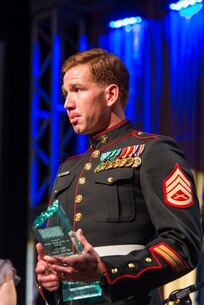 Staff Sgt. Andres Rodriguez gives his acceptance speech after being named the USO North Carolina Marine of the Year at the 2015 Annual Salute to Freedom Gala in Durham, N.C., Oct. 3, 2015. Congressman David Price, 4th District of NC presented each honoree with The U.S. flag flown over the Capitol in Washington DC.
