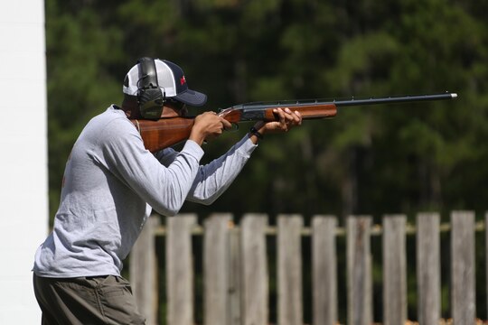 Staff Sgt. Harrison Porquin fires a shotgun at a moving target during a skeet range at Marine Corps Air Station Cherry Point, N.C., Oct. 7, 2015. Marines with 2nd Low Altitude Air Defense Battalion held a weapons safety class and participated in the range as part of their Firearms Mentorship Program to promote proper weapons safety and education in a recreational manner. The program allows Marines to maintain their basic rifleman skills and receive further education on safety measures while handling weapons. Porquin is a warehouse chief with the battalion. (U.S. Marine Corps photo by Cpl. N.W. Huertas/Released)    