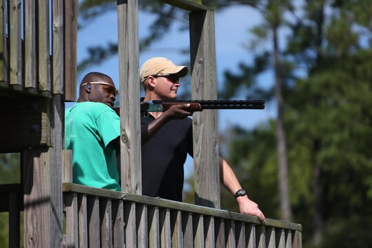 Cpl. Adelius Johnson aims his shotgun at a moving target during a skeet range at Marine Corps Air Station Cherry Point, N.C., Oct. 7, 2015. Marines with 2nd Low Altitude Air Defense Battalion held a weapons safety class and participated in the range as part of their Firearms Mentorship Program to promote proper weapons safety and education in a recreational manner. The program allows Marines to maintain their basic rifleman skills and receive further education on safety measures while handling weapons. Johnson is a field radio operator with the battalion. (U.S. Marine Corps photo by Cpl. N.W. Huertas/Released)   