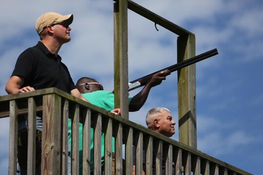 Cpl. Adelius Johnson fires his shotgun at a moving target during a skeet range at Marine Corps Air Station Cherry Point, N.C., Oct. 7, 2015. Marines with 2nd Low Altitude Air Defense Battalion held a weapons safety class and participated in the range as part of their Firearms Mentorship Program to promote proper weapons safety and education in a recreational manner. The program allows Marines to maintain their basic rifleman skills and receive further education on safety measures while handling weapons. Johnson is a field radio operator with the battalion. (U.S. Marine Corps photo by Cpl. N.W. Huertas/Released)    