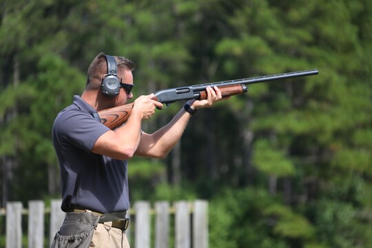 1st Lt. Benjamin Pearce fires his shotgun at a moving target during a skeet range at Marine Corps Air Station Cherry Point, N.C., Oct. 7, 2015. Marines with 2nd Low Altitude Air Defense Battalion held a weapons safety class and participated in the range as part of their Firearms Mentorship Program to promote proper weapons safety and education in a recreational manner. The program allows Marines to maintain their basic rifleman skills and receive further education on safety measures while handling weapons. Pearce is the adjutant with the battalion.(U.S. Marine Corps photo by Cpl. N.W. Huertas/Released)   