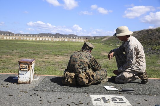 Lance Cpl. Toby R. Baker, marksmanship coach, Edson Range, Marine Corps Base Camp Pendleton, Calif., helps Recruit Dalton H. Kirksey apply the proper marksmanship fundamentals during Rifle Week at Edson Range, Marine Corps Base Camp Pendleton, Calif., Oct. 8. The coaches spend one entire week with their recruits making sure they are comfortable with their weapons and they understand the fundamentals of shooting. Today, all males recruited from west of the Mississippi are trained at MCRD San Diego. The depot is responsible for training more than 16,000 recruits annually. Hotel Company will graduate Nov. 20.