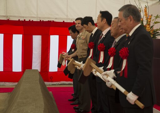 Col. Robert V. Boucher, commanding officer of Marine Corps Air Station Iwakuni, Japan, and Japanese dignitaries wait for the command to break dirt at the ground breaking ceremony at Atagoyama Baseball Field in Iwakuni City, Oct. 15, 2015. The Government of Japan purchased Atagoyama in 2012 in support of the Iwakuni Runway Relocation Project. The site provided the dirt and sand used to construct Iwakuni’s new runway.
