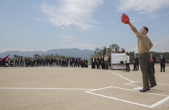Col. Robert V. Boucher, commanding officer of Marine Corps Air Station Iwakuni, Japan, catches Yoshihika Fukuda’s, mayor of Iwakuni City, first pitch at the ground breaking ceremony of Atagoyama Baseball Field in Iwakuni City, Oct. 15, 2015. The baseball field is designed for the shared use with local citizens and U.S. forces.