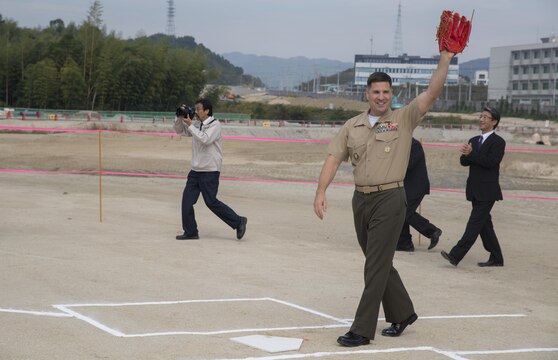 Col. Robert V. Boucher, commanding officer of Marine Corps Air Station Iwakuni, Japan, waves after the first pitch at the ground breaking ceremony at Atagoyama Baseball Field in Iwakuni City, Oct. 15, 2015. A first pitch on the future baseball field demonstrated the special bond between Iwakuni City and the air station.