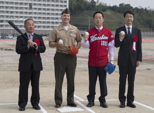 Toshiyuki Kuwahara, chairman of Iwakuni City Assembly, Col. Robert V. Boucher, commanding officer of Marine Corps Air Station Iwakuni,  Yoshihiko Fukuda, mayor of Iwakuni City, and Takahiro Sugawara, director general of Chugoku-Shikoku Defense Bureau, pose for a picture after the first pitch at the ground breaking ceremony of Atagoyama Baseball Field in Iwakuni City, Japan, Oct. 15, 2015. Atagoyama provided the dirt and sand used in constructing a new runway on MCAS Iwakuni. The ground breaking ceremony represented the construction of the baseball field and future U.S. – Japan relationships.