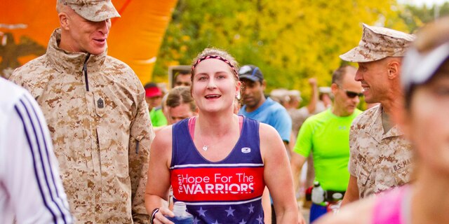 Sergeant Maj. Thomas L. Johnson, left, Sgt. Amamda Eason and Commanding Officer Col. Todd J. Oneto, all from Headquarters and Service Battalion, attend the Marine Corps Marathon Oct. 25 in Arlington, Va. Oneto and Johnson congratulate Eason on the completion of her fifth marathon.   Throughout her career in garrison and combat, Eason has served in multiple billets to include company gunnery sergeant where she participated in more than 30 convoy missions in Afghanistan. 