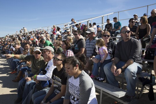 Marines, their families and guests of Marine Light Helicopter Attack Training Squadron (HMLAT) 303, fill the bleachers prior to an aerial demonstration aboard Marine Corps Base Camp Pendleton, Calif., Oct. 24. Marines and their family members visited one of Camp Pendleton’s ranges during family to experience firing a service rifle and observe a live, aerial demonstration. (U.S. Marine Corps photo by Sgt. Lillian Stephens/Released)