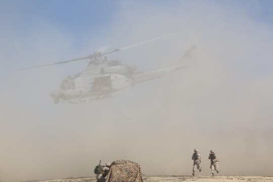 Marines with Marine Light Helicopter Attack Training Squadron (HMLAT) 303 disembark a UH-1Y Huey during an aerial demonstration aboard Marine Corps Base Camp Pendleton, Calif., Oct. 24. During the demonstration, Marines on the ground communicated with helicopters to perform a multi-phase, live-fire event. (U.S. Marine Corps photo by Sgt. Lillian Stephens/Released)