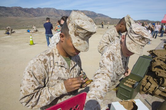 Marines with Marine Light Helicopter Attack Training Squadron (HMLAT) 303 load magazines for a live-fire event aboard Marine Corps Base Camp Pendleton, Calif., Oct. 24. Guests of HMLAT-303 visited one of Camp Pendleton’s ranges during the HMLAT-303 Family Day event to experience firing a service rifle and watch an aerial demonstration. (U.S. Marine Corps photo by Sgt. Lillian Stephens/Released)