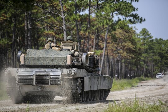 Marines with Alpha Company, 2nd Tank Battalion, make their way to Landing Zone Dodo to meet Marines with Golf Company, 2nd Battalion, 2nd Marine Regiment, during an integrated exercise at LZ Dodo, Camp Lejeune, N.C., Sept. 2, 2015. The purpose of the exercise was to allow Marine infantry and tankers to work together. (U.S. Marine Corps photo by Cpl. Paul S. Martinez/Released)