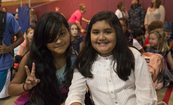 Leslie Reyna, left, and Alani Rodriguez pose for a picture on the first day of the school year at Matthew C. Perry Elementary School aboard Marine Corps Air Station Iwakuni, Japan, Aug. 31, 2015. Students assembled according to grade in M. C. Perry’s gymnasium to ring in the new school year.