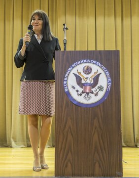 Dr. Suzanne Landrum, principle of Matthew C. Perry Elementary School, addresses students, staff and parents on the first day of the new school year aboard Marine Corps Air Station Iwakuni, Japan, Aug. 31, 2015. Landrum encourages parents and community members to be a part of the classroom environment and volunteer at the elementary school.