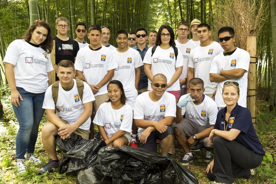 Volunteers pose for a group photo after picking up trash at the Kintai-area in Iwakuni, Japan, during a community relations event hosted by the Single Marine Program aboard Marine Corps Air Station Iwakuni, Japan, Sep. 4, 2015. Approximately 24 volunteers spent more than two hours picking up litter along the side of the road.