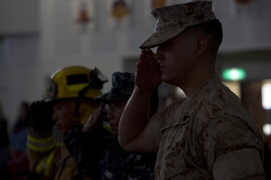 Station residents attend the 9/11 remembrance service at Marine Memorial Chapel aboard Marine Corps Air Station Iwakuni, Japan, Sept. 11, 2015. The service honored those who lost thier lives 14 years ago.