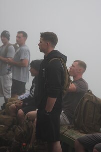 AAV Company Marines Cpl. Garrett Warner, 1st Lt. Jacob Brown, 1st Lt. Matthew Franco, Cpl. Robert McCarthy, and Cpl. Daniel Morton wait for stamps on their walking sticks on their way to the summit of Mount Fuji, Japan. AAV Company Marines are part of Task Force Iron Fist 4 out of Camp Fuji, Japan.