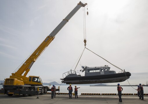 Harbor Operations personnel help guide a boat into the harbor for training aboard Marine Corps Air Station Iwakuni, Japan, Sept. 2, 2015. The PBH-1, harbor patrol boat, is the combat ready boat for the harbor. The PBH-1 is unique because it is a jet propelled boat that uses buckets for propulsion, making it possible to walk the boat up to a pier or into a tight space.(U.S. Marine Corps photo by Lance Cpl. Nicole Zurbrugg/Released)