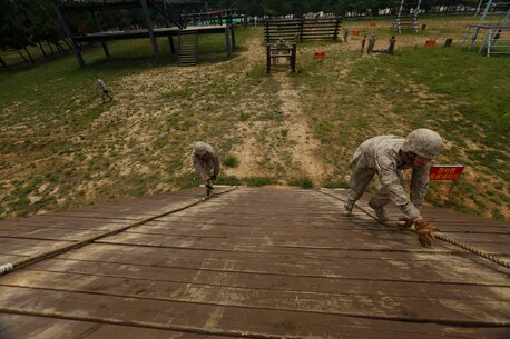 U.S. Marines attached to 2d Battalion, 3d Marines, Weapons Company, conduct a Republic of Korea Marine Corps obstacle course during Korean Marine Exchange Program 15-19 (KMEP) on Camp Mujuk, Republic of Korea, June 22, 2015. KMEP 15-19 provided an opportunity to train the units’ complex Company and Battalion level collective tasks on dynamic, combined-arms ranges. (U.S. Marine Corps photo by MCIPAC Combat Camera Lance Cpl. Colby Cooper/Released)           