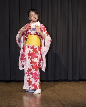 A special guest from the Shunan International Children’s Club performs a cultural dance during the Info Expo inside Club Iwakuni Grand Ballroom aboard Marine Corps Air Station Iwakuni, Japan, Sept. 12, 2015. The Info Expo provided an opportunity for the local Japanese community to visit the air station, share their cultural heritage and invite station residents to explore local venues.