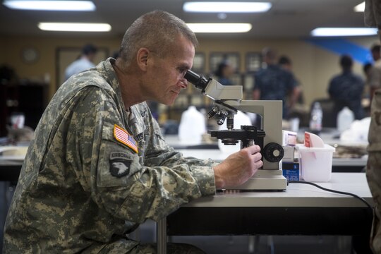A soldier examines a blood sample during the practical application portion of the Walter Reed Army Institute of Research’s Operational Clinical Infectious Diseases course held aboard Marine Corps Base Camp Lejeune, N.C., Sept. 10, 2015. Special Amphibious Reconnaissance Corpsmen and MARSOC medical practitioners took advantage of the course to better prepare for future deployments.