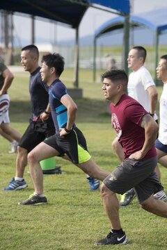 Sgt. Antonio Rubio, a combat correspondent with Headquarters and Headquarters Squadron, leads Japan Ground Self-Defense Force members in a Marine Corps style physical training session during an English seminar at Marine Corps Air Station Iwakuni, Japan, Sept. 15, 2015. During the two-day seminar, JGSDF translators learned how Marines operate in their military occupational specialties, physically train and work to uphold Marine Corps standards as a fighting force.