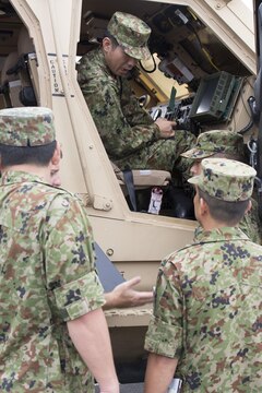 Japan Ground Self-Defense Force members take a look inside a mine-resistant ambush-protected all-terrain vehicle during an English seminar at Marine Corps Air Station Iwakuni, Japan, Sept. 15, 2015. Members of the JGSDF received several English classes, physically trained with Marines and toured the installation during the two-day English seminar. The seminar helped the JGSDF members understand commonly used English idioms and gave them a look at the day to day operations of the air station.