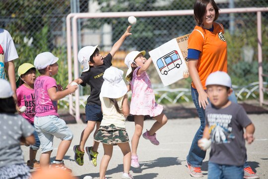 Cpl. Tiffany Ackerman, an air freight clerk with Headquarters and Headquarters Squadron, plays a game with preschoolers at Kawashimo Preschool, Iwakuni, Yamaguchi Prefecture, Japan, Sept. 29, 2015. Service members from Marine Corps Air Station Iwakuni volunteered for the opportunity to develop a bond with the children of Japan. 